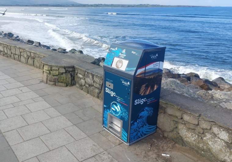 BriteBin™ compacting bin positioned along a scenic pedestrian walkway to reduce litter and support cleaner streets.