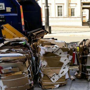 cardboard bales outside waste collection van on street