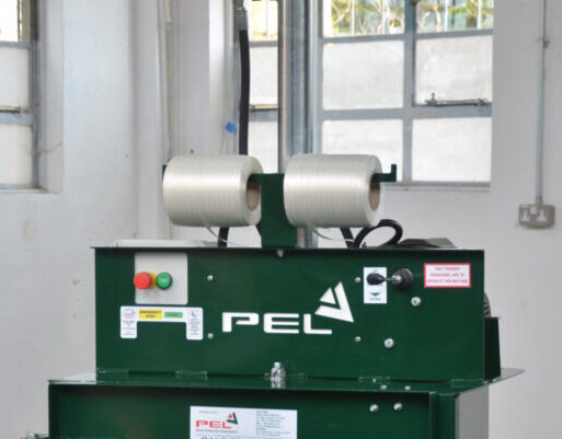 Two rolls of PEL Baler strapping on baler in warehouse